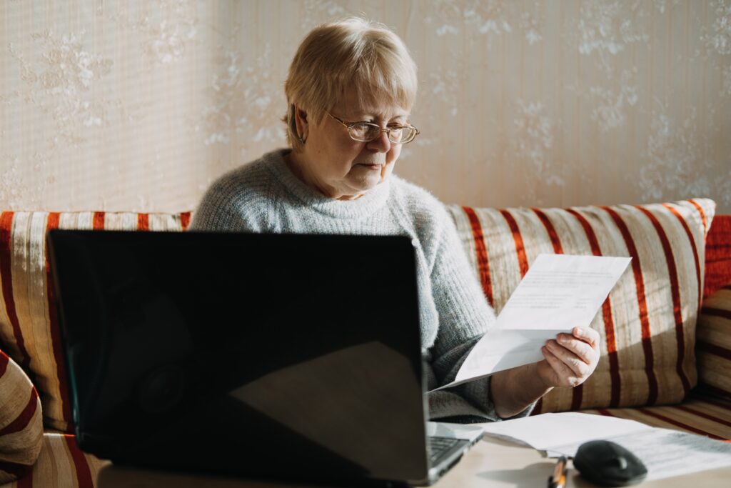 senior-woman-computer-laptop-bill-financial-money-older-paper-business-online-home-document-aged