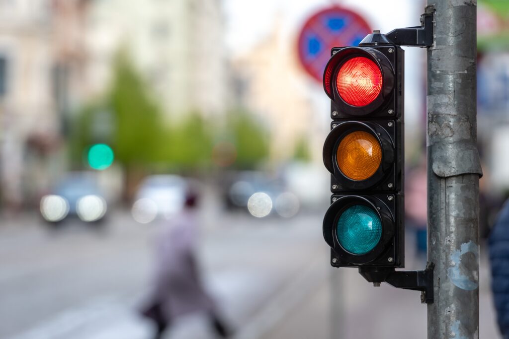 A city crossing with a semaphore. Red light in semaphore