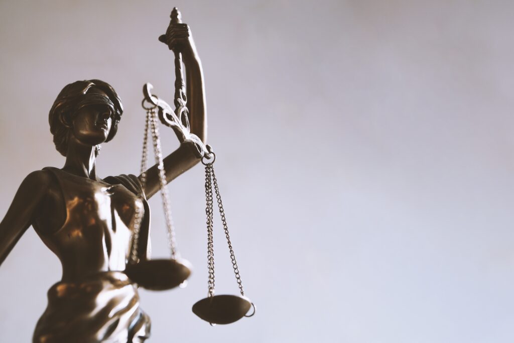 lady justice or justitia figurine - law and jurisprudence symbol