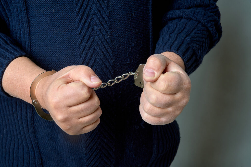 Male hands in handcuffs close-up